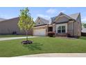 Inviting single-Gathering home with a manicured lawn and stone accents on the facade in a Gathering-friendly community at 238 Dorothy Ln, Lawrenceville, GA 30046