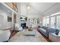 Bright living room with fireplace, soaring ceilings, and walls of windows at 315 Mossy Pointe, Duluth, GA 30097