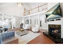 Bright living room with fireplace, soaring ceilings, and a view of the upper level at 315 Mossy Pointe, Duluth, GA 30097