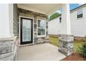 Covered front porch with stone accents, providing an inviting and stylish entryway to the home at 4785 Marjorie Dr, Cumming, GA 30041