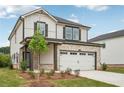 Two-story house shows a two-car garage, lawn, and landscaped beds at 4830 Marjorie Dr, Cumming, GA 30041