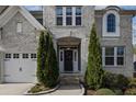 Beautiful home featuring a well-manicured front yard and a welcoming front door flanked by evergreen shrubs at 5153 Elkins Ln, Acworth, GA 30101