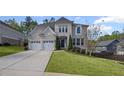 Beautiful home with a well-maintained lawn, a long driveway, and a two-car garage at 5153 Elkins Ln, Acworth, GA 30101