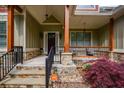 Stone steps leading up to a covered front porch with stone supports and a Vivint smart home sign at 773 Pebblebrook Rd, Mableton, GA 30126