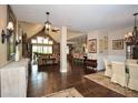 Open-concept living space with hardwood floors, vaulted ceilings, and multiple seating areas at 773 Pebblebrook Rd, Mableton, GA 30126