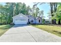 One-story home with a concrete driveway and a well-manicured lawn at 4640 Lambton Cir, Suwanee, GA 30024
