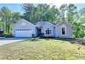 Well-maintained one-story home with a two car garage and manicured lawn at 4640 Lambton Cir, Suwanee, GA 30024