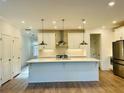 Spacious kitchen featuring a large island, stainless steel appliances, and modern lighting at 102 Birch Tree Way, Cumming, GA 30040