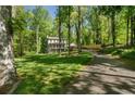 Beautiful two-story home with a lush, tree-filled yard, long driveway, and convenient carport at 105 Woodmeade Nw Way, Marietta, GA 30064