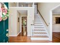 Inviting foyer with hardwood floors, staircase and view into living spaces at 744 Edgewater Nw Ln, Kennesaw, GA 30144