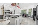 Bright kitchen with granite counters, wine rack, stainless steel appliances, and a center island at 815 Connell Ln, Lawrenceville, GA 30044