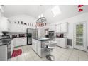 Bright and spacious kitchen with stainless appliances, tile floors, white cabinets, and a center island at 815 Connell Ln, Lawrenceville, GA 30044