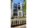 Charming townhome features a private balcony, black framed windows, and a classic white brick facade at 1268 Appleden Way # 17, Brookhaven, GA 30319