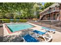 Sparkling community pool surrounded by lounge chairs and lush greenery for ultimate relaxation at 4282 Roswell Ne Rd # C3, Atlanta, GA 30342