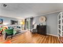 Inviting living room with hardwood floors, a cozy grey sofa and accent furniture at 6900 Roswell Rd # Q26, Atlanta, GA 30328