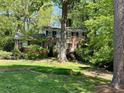 Traditional two-story brick home nestled among mature trees and greenery at 2603 Kings Lake Ne Ct, Atlanta, GA 30345