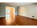 Spacious living room with hardwood floors and an open layout to the dining area at 2603 Kings Lake Ne Ct, Atlanta, GA 30345
