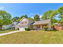 Attractive two-story home with red shutters, a two-car garage, and green lawn at 6396 Phillips Ct, Lithonia, GA 30058
