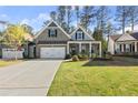 Beautiful home with a well-manicured lawn and a long driveway at 809 Kirby Dr, Woodstock, GA 30188