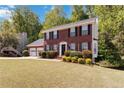 Traditional two-story home with a manicured lawn, landscaping, and an attached two car garage at 850 Madison Chase Way, Lawrenceville, GA 30045