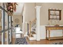 Inviting home entryway with hardwood floors, decorative wainscoting, an elegant staircase, and stylish console table at 117 Manous Dr, Canton, GA 30115