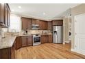 Spacious kitchen with stainless steel appliances, granite countertops, hardwood floors, and ample cabinet space at 117 Manous Dr, Canton, GA 30115