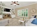 Cozy living room with stone fireplace, plantation shutters, built-in bookshelves, and comfortable seating at 117 Manous Dr, Canton, GA 30115