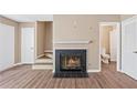 Cozy living room features hardwood floors and a gas fireplace with tiled hearth at 223 Chads Ford Way, Roswell, GA 30076