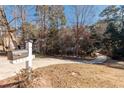Long driveway leading to a home surrounded by trees, with a mailbox in the foreground at 3235 Crestview Dr, Cumming, GA 30041
