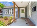 Inviting covered front porch with wood columns, a bench, and a view of the charming exterior at 756 Ormewood Se Ave, Atlanta, GA 30312