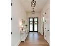 Inviting hallway with hardwood floors, elegant lighting, and a stylish console table at 2235 Birchtree Way, Marietta, GA 30062