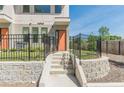 Inviting front entrance featuring concrete stairs, a black metal fence and landscaped yard at 1300 Memorial Se Dr # 12, Atlanta, GA 30317