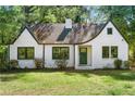 Charming white brick home featuring a well-manicured lawn and classic architectural details at 1027 Mount Airy Sw Dr, Atlanta, GA 30311