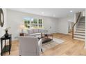 Bright and airy living room with hardwood floors, modern furniture, and a large window at 3107 Park Ln, Snellville, GA 30078