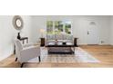 Inviting living room featuring hardwood floors, a cozy sofa, and contemporary decor at 3107 Park Ln, Snellville, GA 30078