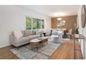 Bright and open living room featuring hardwood floors, a large window, and stylish neutral-toned furnishings at 3200 Rehoboth Dr, Decatur, GA 30033