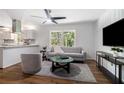 Inviting living space featuring a modern ceiling fan, contemporary furniture, and a view into the adjacent kitchen at 3200 Rehoboth Dr, Decatur, GA 30033