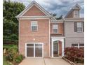 Beautiful brick front home featuring an attached garage and landscaped front yard at 5260 Sherwood Way, Cumming, GA 30040