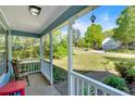 Inviting covered porch with white railings and view of landscaped yard at 111 Amberwood Ln, Euharlee, GA 30145
