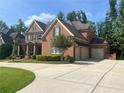 Beautiful brick home with a three-car garage and expansive driveway at 2331 Kinsale Nw Pt, Kennesaw, GA 30152