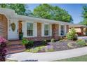 Inviting front entrance with brick steps, decorative door, and beautifully planted flowerbeds at 3397 Old Jonesboro Rd, Hapeville, GA 30354