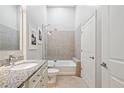 Bright bathroom featuring a granite vanity, neutral tile flooring, and a shower and tub at 44 Peachtree Nw Pl # 528, Atlanta, GA 30309