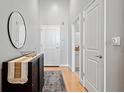 Entryway with dark console table, modern mirror, light gray walls, and hardwood floors at 44 Peachtree Nw Pl # 528, Atlanta, GA 30309
