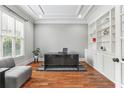 Home office with hardwood floors, built-in shelving, desk, and large window at 5422 Heyward Square Pl, Marietta, GA 30068