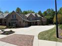 Beautiful brick home with an expansive driveway and well-maintained landscaping at 187 Slate Dr, Buford, GA 30518