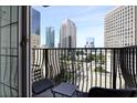 Apartment balcony with seating area and views of downtown skyline at 195 14Th St # 1403, Atlanta, GA 30309