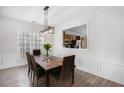 Cozy dining room with modern chandelier and a view to the kitchen at 4930 Kings Common Way, Cumming, GA 30040