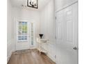 Bright entryway with stylish console table, and tiled floor at 4930 Kings Common Way, Cumming, GA 30040