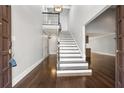 Inviting foyer with a staircase, hardwood floors, and a view into the living area at 1205 Club Walk Ne Dr, Brookhaven, GA 30319