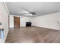 Spacious living room featuring hardwood floors, a ceiling fan, and stylish brick accent wall with barn door at 1217 Topaz Ln, Villa Rica, GA 30180